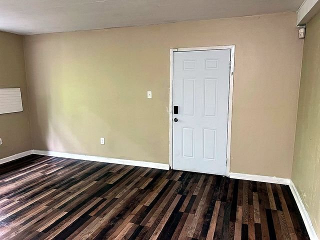 1 Bedroom Apartment at Superior Hill #1G, East Cleveland OH — A room with wood-look flooring and a white door.
