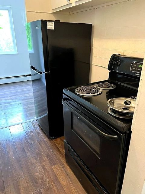 1 Bedroom Apartment at Superior Hill #1G, East Cleveland OH — A kitchen with a refrigerator and stove.