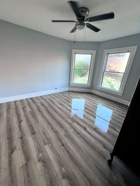 2 Bedroom Apartment at 51 Cotter #4, Akron OH — Bedroom with gray walls, wood-look flooring, and two windows.