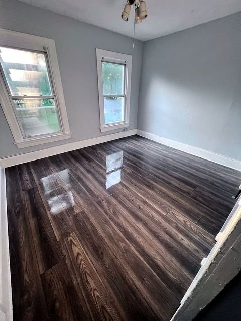 2 Bedroom Apartment at 51 Cotter #4, Akron OH — Bedroom with gray walls and dark wood-look flooring.