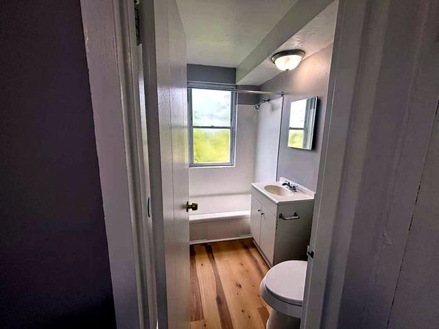 1 Bedroom Apartment at Superior Hill #7B, East Cleveland OH — A small bathroom with a bathtub, toilet, and sink.