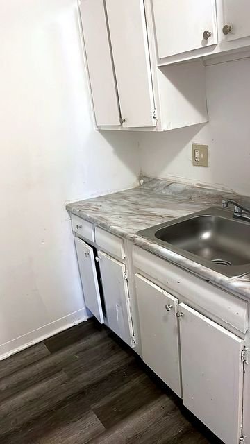 1 Bedroom Apartment at Allen House #105, Cleveland OH — A small kitchen with white cabinets and countertops.