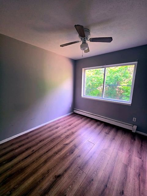 2 Bedroom Apartment at Allen House #208, Cleveland OH — Bedroom with wood-look flooring, window and ceiling fan.