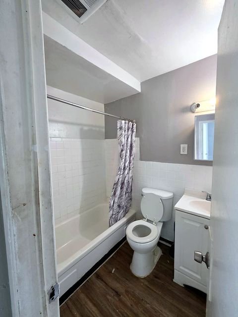 2 Bedroom Apartment at Allen House #208, Cleveland OH — A bathroom with a bathtub, toilet, and vanity.