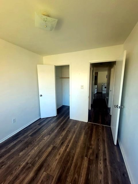 3 Bedroom Apartment at Allen House #307, Cleveland OH — A living room with two doorways and wood-look flooring.