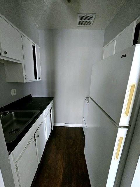 3 Bedroom Apartment at Allen House #307, Cleveland OH — A small kitchen with white cabinets and a stainless steel sink.