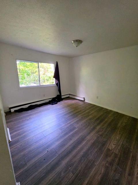 3 Bedroom Apartment at Allen House #307, Cleveland OH — Empty bedroom with wood-look flooring and a window.