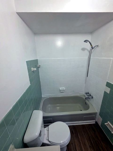 3 Bedroom Apartment at Allen House #307, Cleveland OH — A bathroom with a bathtub and toilet.