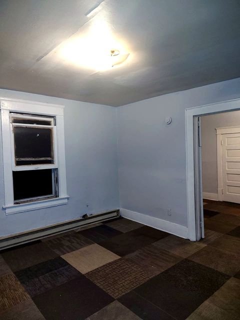 1 Bedroom Apartment at Chittenden #7, Akron OH — A room with carpet tiles, a window and doorway.