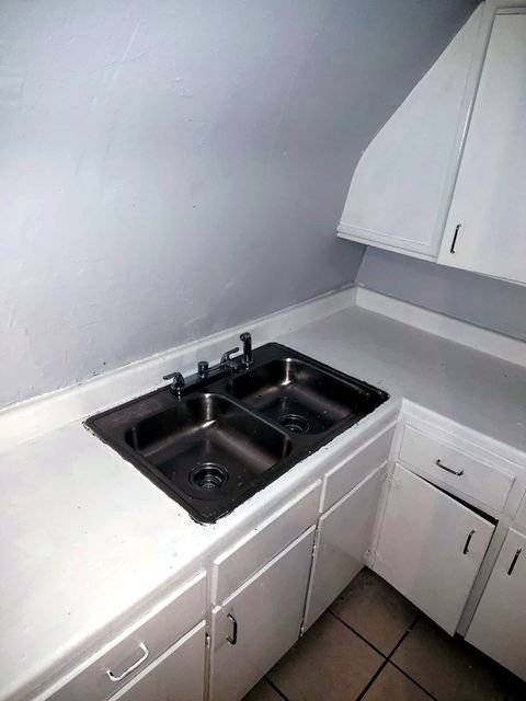 1 Bedroom Apartment at Chittenden #7, Akron OH — A stainless steel double sink and white cabinets are visible in a kitchen.