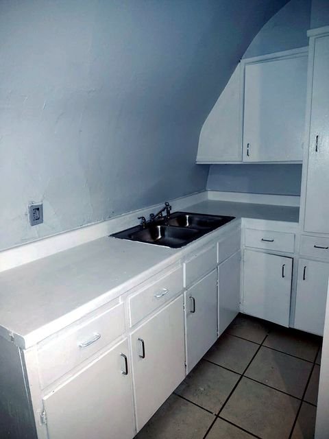 1 Bedroom Apartment at Chittenden #7, Akron OH — A kitchen with white cabinets and a sink.