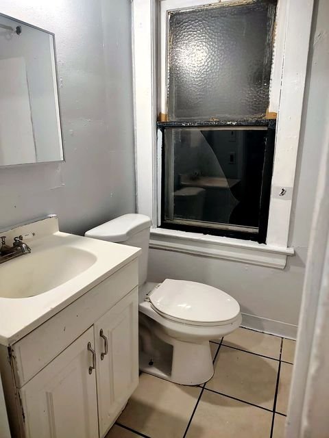 1 Bedroom Apartment at Chittenden #7, Akron OH — A small bathroom with a toilet, sink and window.