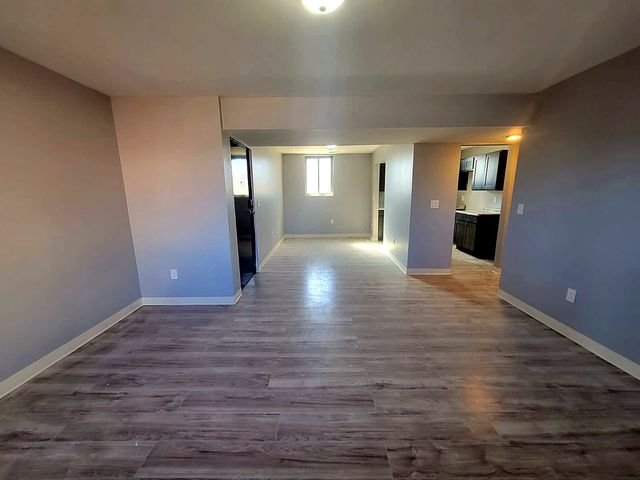 3 Bedroom Apartment at Dayton Apartments #1804 - Unit A, Dayton OH — An empty living room with gray flooring and light blue walls.