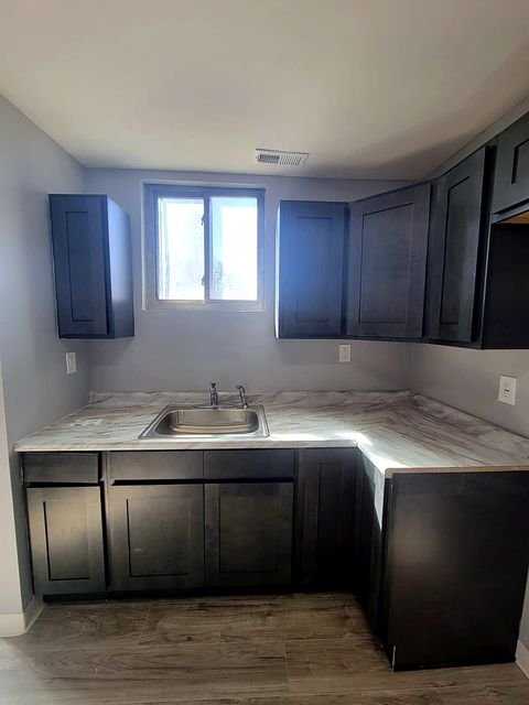 3 Bedroom Apartment at Dayton Apartments #1804 - Unit A, Dayton OH — A kitchen with dark cabinets and light countertops.