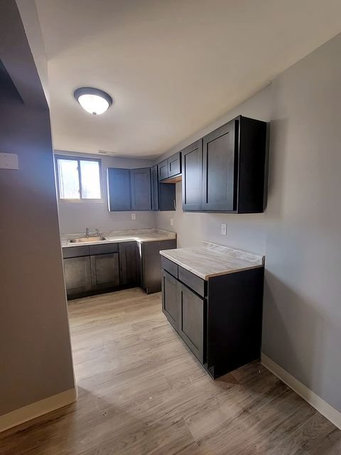3 Bedroom Apartment at Dayton Apartments #1804 - Unit A, Dayton OH — A kitchen with dark cabinets and light countertops.