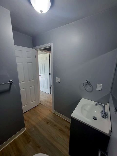 3 Bedroom Apartment at Dayton Apartments #1804 - Unit A, Dayton OH — A bathroom with gray walls, white door and sink.