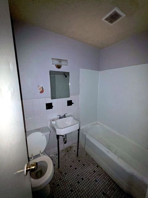 1 Bedroom Apartment at Grovewood #2, Cleveland OH — A bathroom with a toilet, sink, and bathtub.