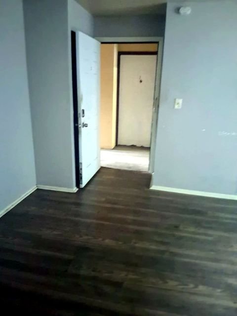 1 Bedroom Apartment at Grovewood #2, Cleveland OH — Hallway with two doors and gray flooring.