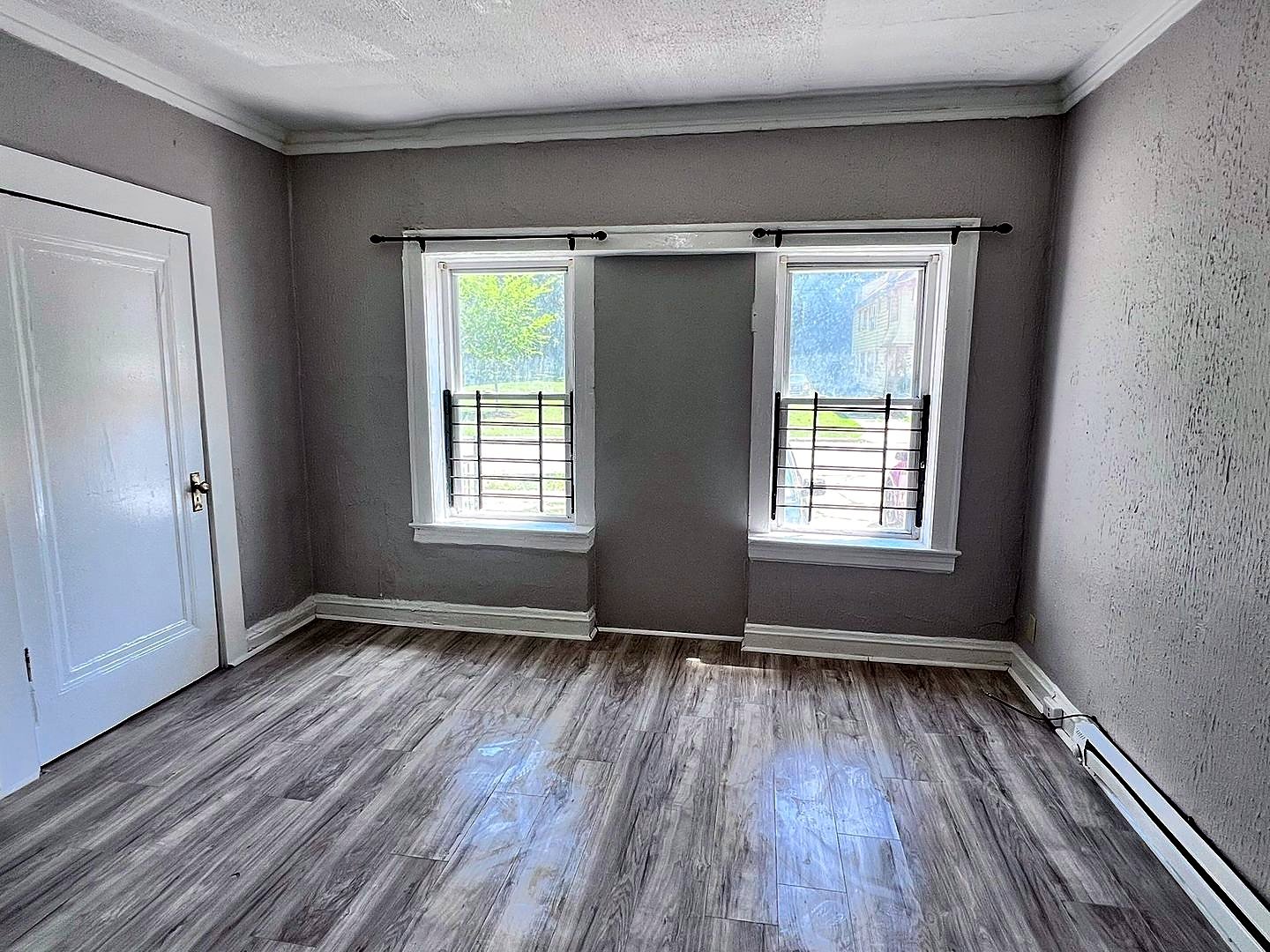 1 Bedroom Apartment at Linn #9, Cleveland OH — Living room with two windows and wood-look flooring.
