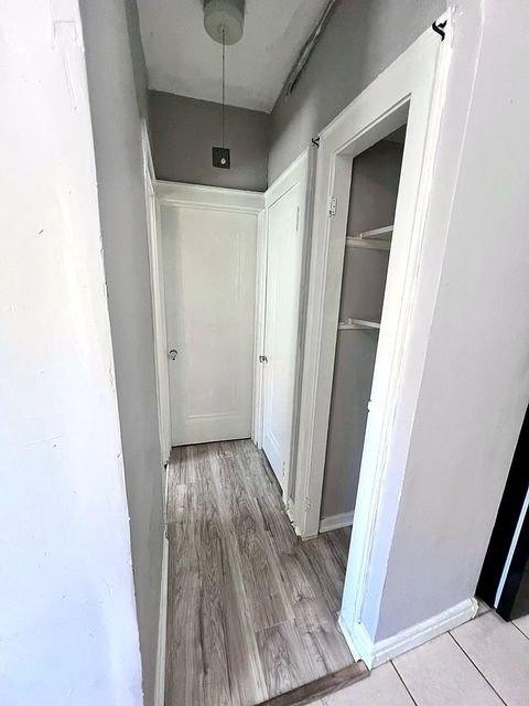 1 Bedroom Apartment at Linn #9, Cleveland OH — A hallway with two doors and tile flooring.