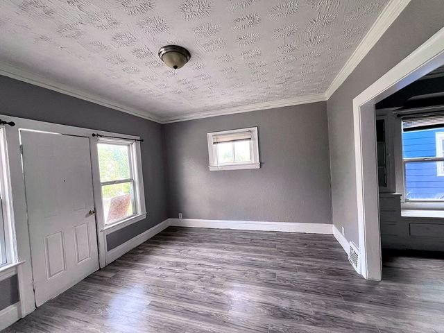 2 Bedroom Apartment at Medellin #1, Cleveland OH — Empty living room with gray walls and wood-look flooring.