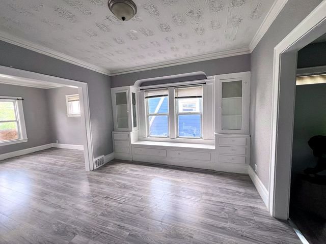 2 Bedroom Apartment at Medellin #1, Cleveland OH — A living room with gray walls, white trim, and wood-look flooring.