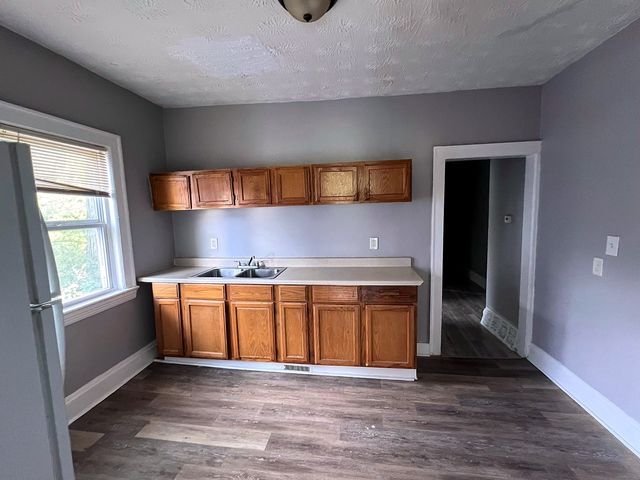 2 Bedroom Apartment at Medellin #1, Cleveland OH — A kitchen with wood cabinets and a small sink.