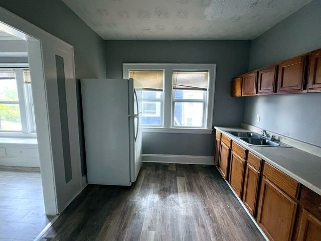 2 Bedroom Apartment at Medellin #1, Cleveland OH — A kitchen with wood cabinets and laminate countertops.