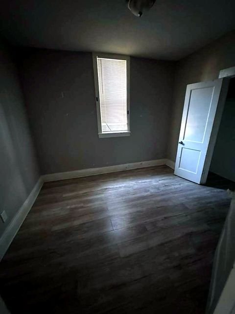 1 Bedroom Apartment at Medellin #4, Cleveland OH — A bedroom with a window and door.