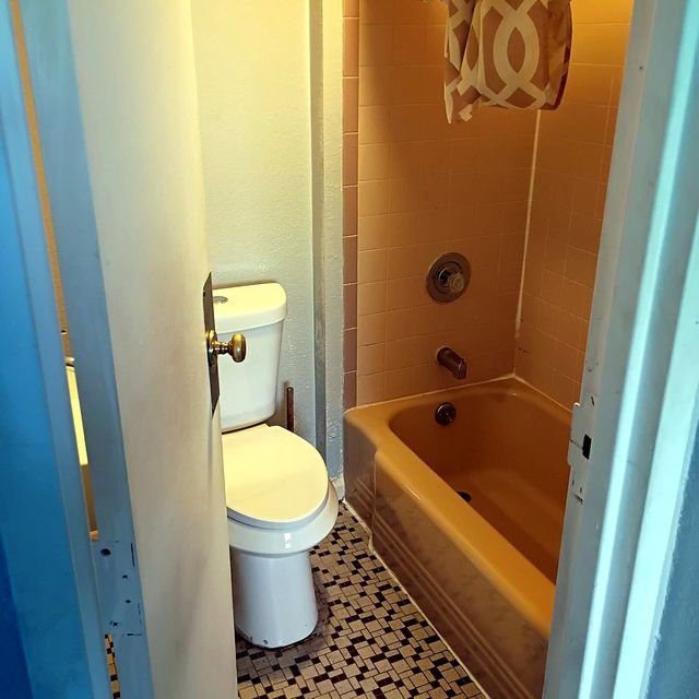 Studio Apartment at Lux Apartments #136, Toledo OH — A bathroom with a toilet, bathtub, and shower.