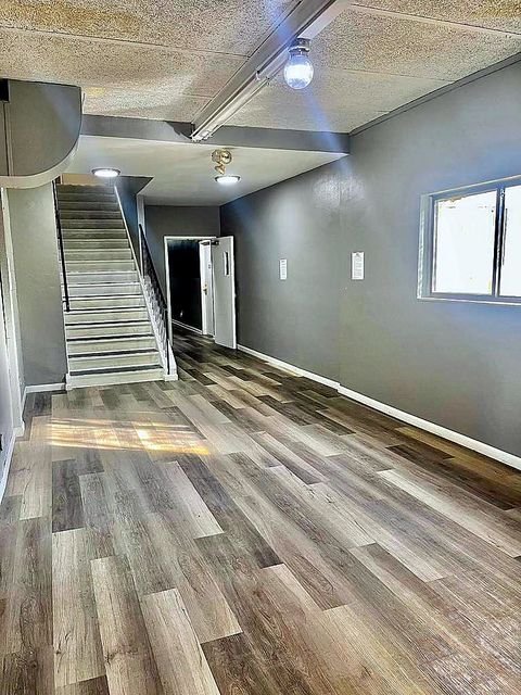 Studio Apartment at Lux Apartments #136, Toledo OH — Hallway with stairs and window.