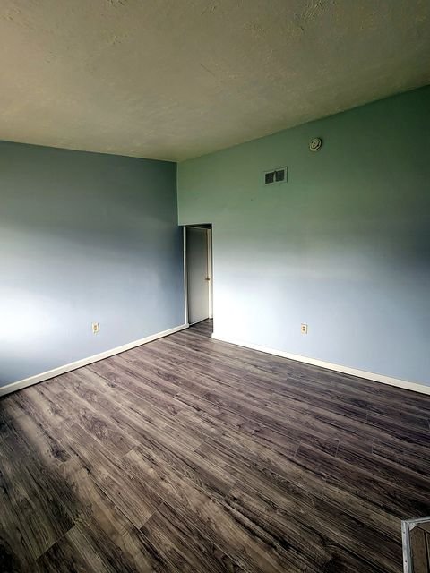 2 Bedroom Apartment at Thurston #1325, Akron OH — A room with light gray wood-look flooring and pale blue walls.