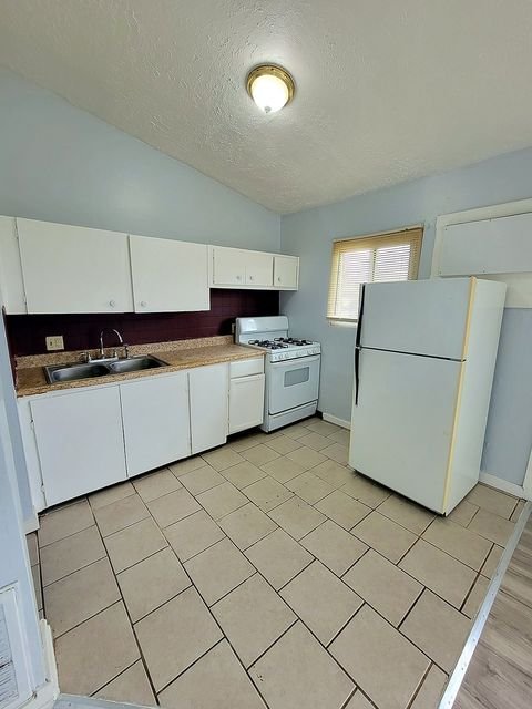 2 Bedroom Apartment at Thurston #1325, Akron OH — A kitchen with white cabinets, tile floor and appliances.
