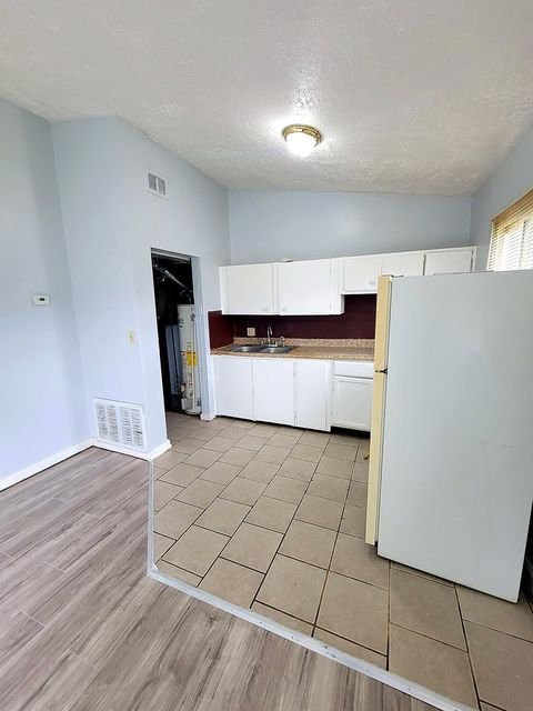 2 Bedroom Apartment at Thurston #1325, Akron OH — A kitchen with white cabinets and tile flooring.