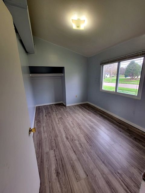 2 Bedroom Apartment at Thurston #1325, Akron OH — Bedroom with light gray wood-look flooring, white walls, and a window.
