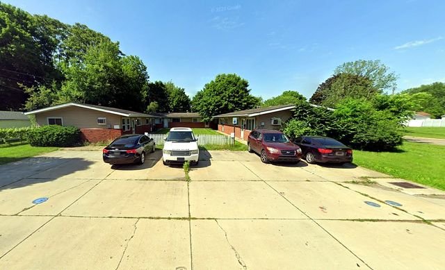 2 Bedroom Apartment at Thurston #1325, Akron OH — Four cars are parked in front of apartment buildings.