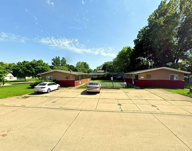 2 Bedroom Apartment at Thurston #1325, Akron OH — A view of three connected houses with cars parked in the driveway.